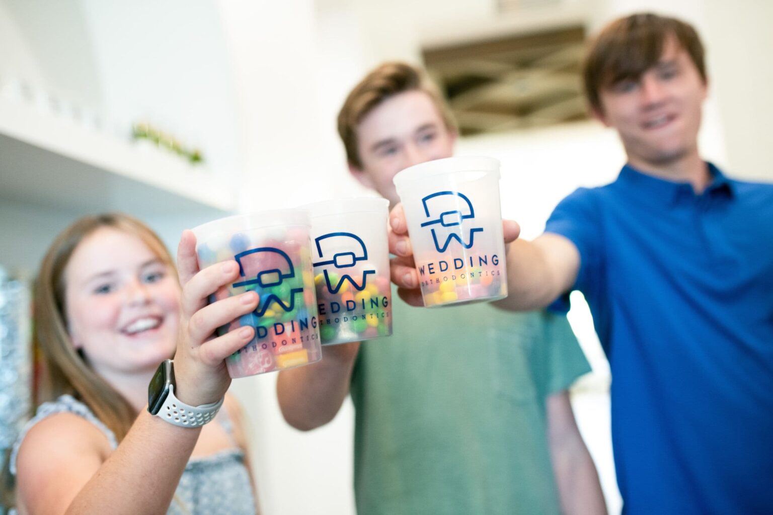 Students holding Wedding Thompson Orthodontics care kits